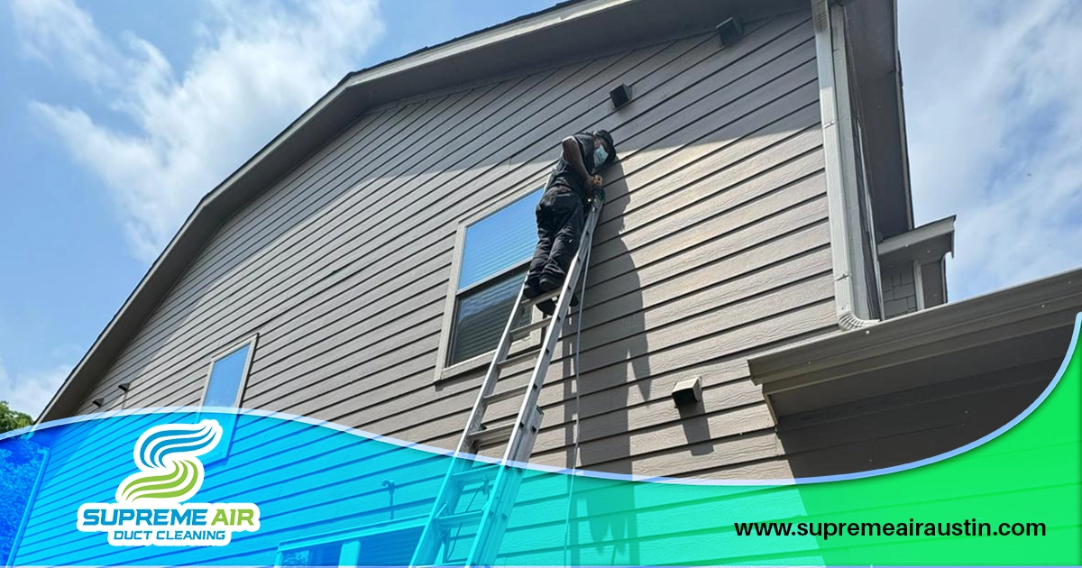 An image shows a technician inspecting the vents outside the house.